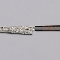 Nigara Kiritsuke Petty SG2 Damascus 150 mm je mali kuhinjski nož za upotrebu kuhinjskih poslova, kod kojih bi veći nož bio nespretan. Jezgra od praškastog čelika SG2 i hamaguri presjek profila jamstvo su dugotrajne oštrine i minimalnog održavanja. Kružni uzorak na oštrici poznat je i kao amatsubu ili uzorak kišnih kapi.
