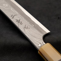 One of the most impressive collector's pieces we have on offer. This spectacular sakimaru yanagiba by the famous Nigara Hamono smithy is a fusion of excellent performance and outstanding aesthetics rarely matched in the world of knives. Core from Aogami #2 steel, twisted damascus lamination, fitted with ebony handle.